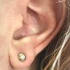 Diamond stud bezel earring piercing